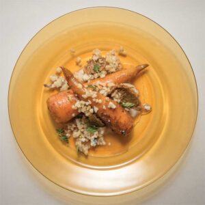 A phot of a roasted honey-glazed carrot dish. 