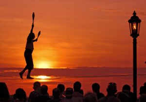 Bob Krist/Courtesy Florida News Bureau A tightrope artist walks during a sunset celebration in Key West, Fla.