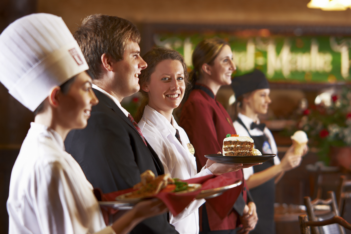 A line of students holding food that they made.