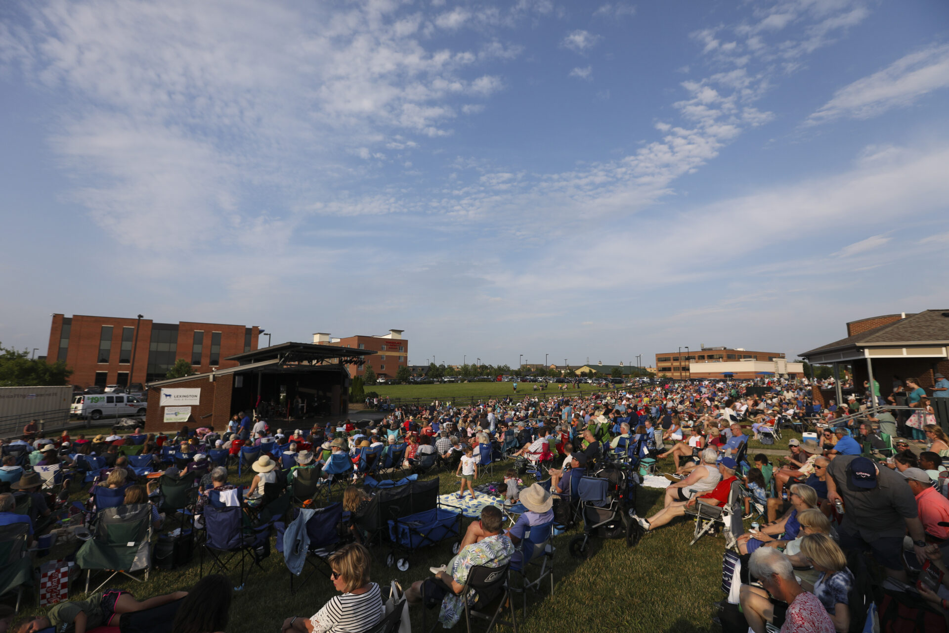 Tiered grass levels where an audience is sitting.