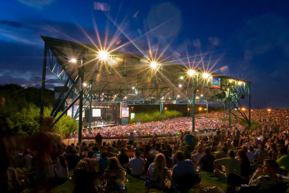 A full crowd at an amphitheater at night.