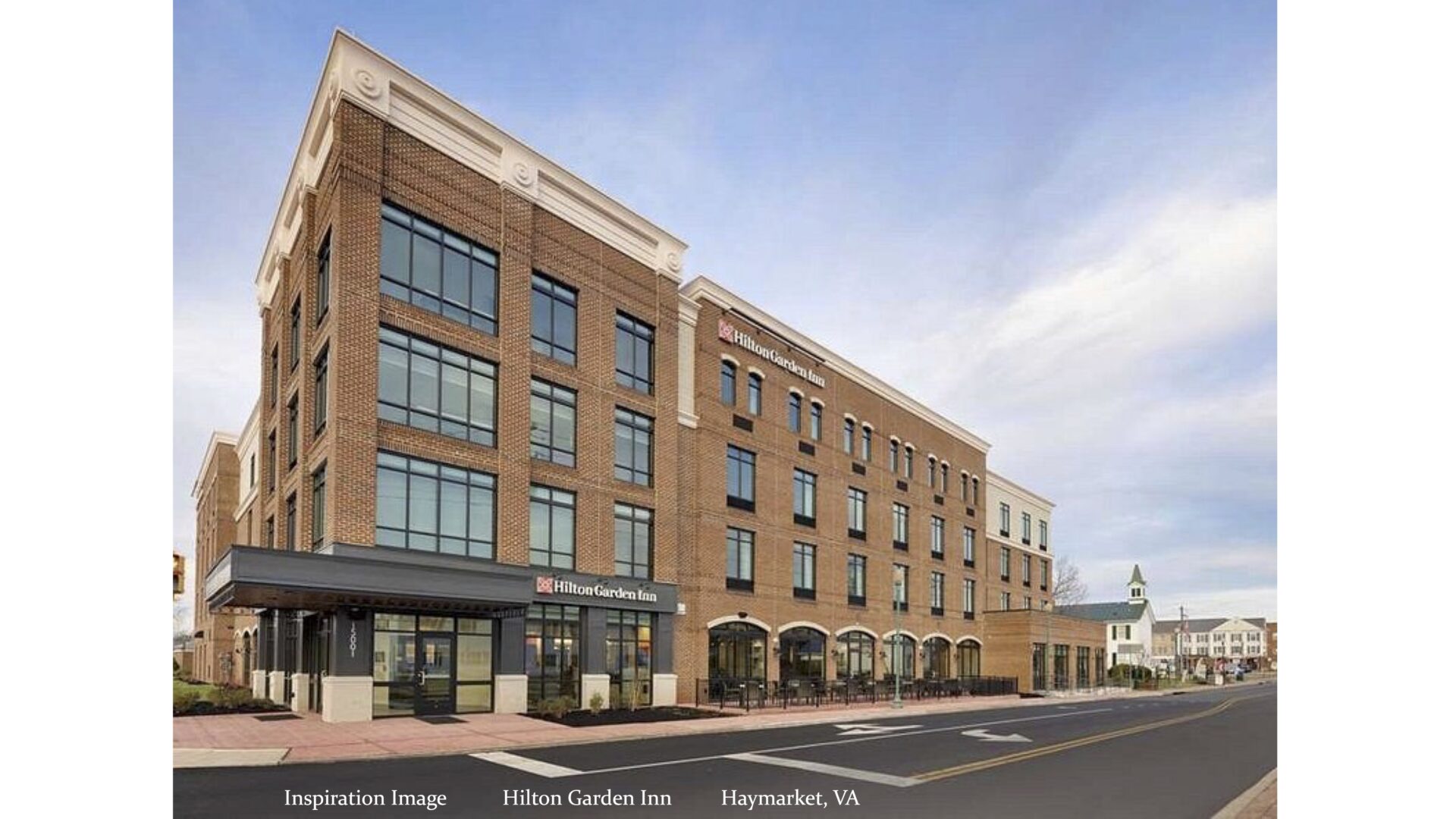 A rendering of Hilton Garden Inn: a brick building with four floors and big windows.