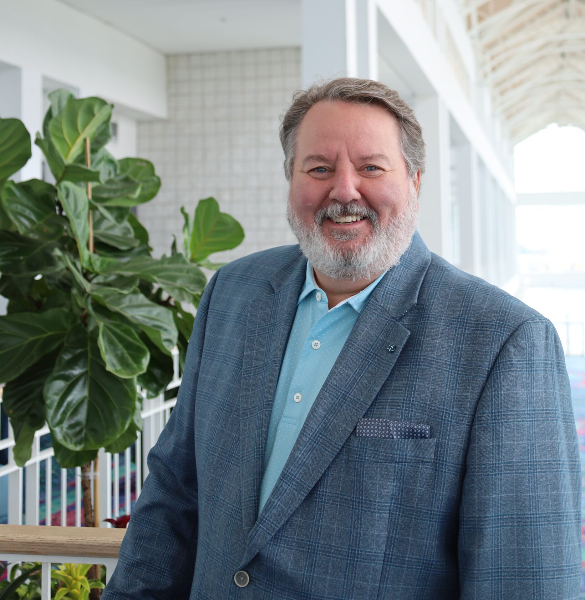 A headshot of Mathew Bryant in a gray blazer.
