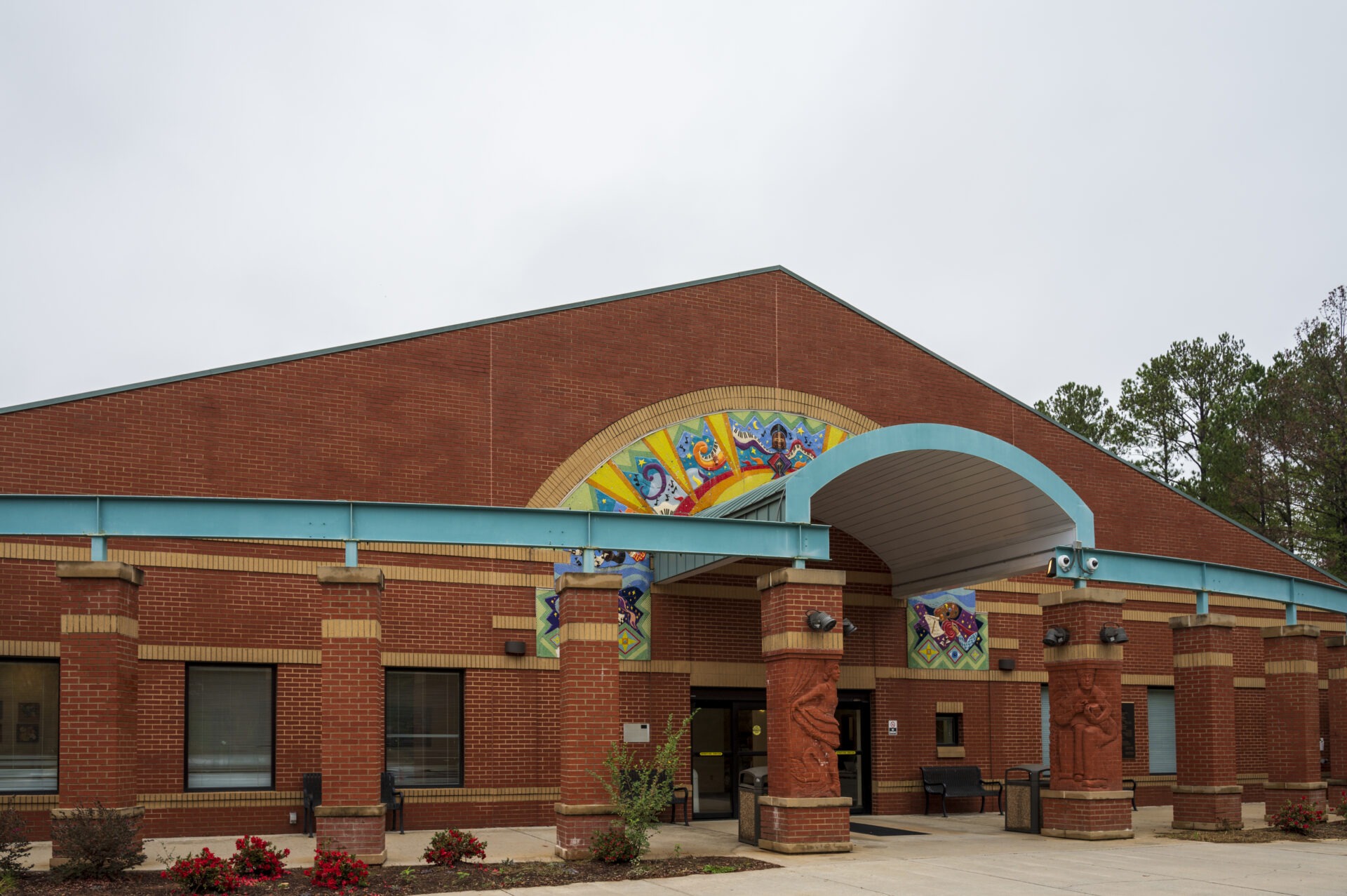 A red brick building with colorful mosaic tiles.
