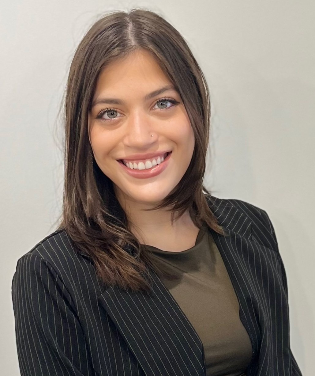 A headshot of Faith Van Deusen with brown, straight hair.
