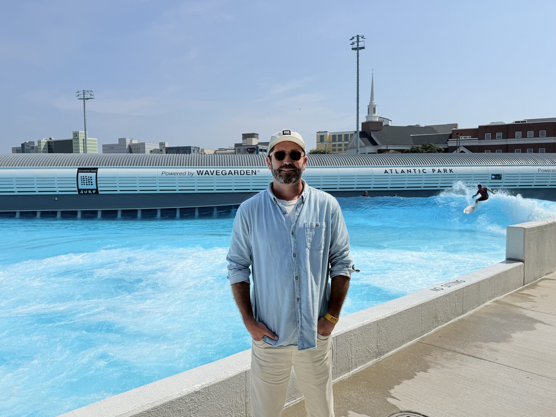 Mike Wallace, Atlantic Park Surf’s vice president of sales, stands beside the surf lagoon in Virginia Beach.